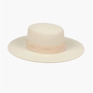 Lack of Color, wide-brimmed boater style. With a gold patterned vintage ribbon,